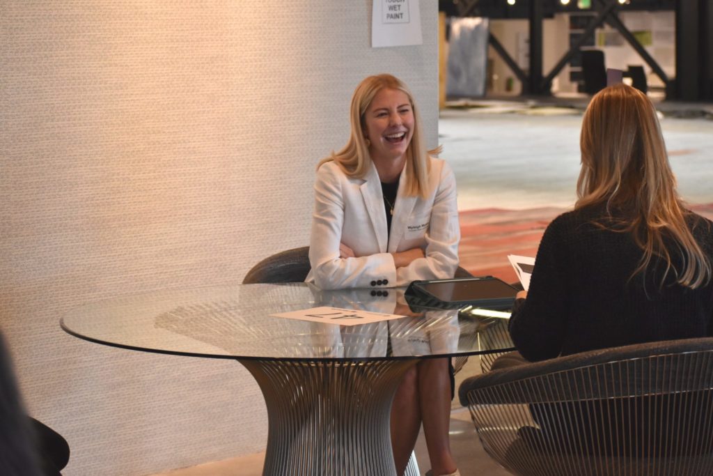 A student laughs as she participates in a mock interview in Denver