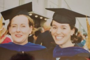 Fruhauf and her mentor stand together in caps and gowns