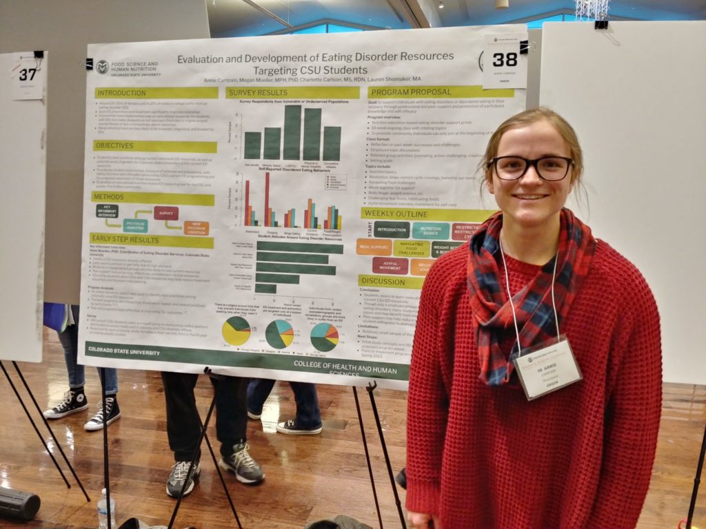 Annie Campain next to her research poster.