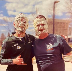 Brendan and instructor Brian Butki covered in whipped cream from being pied 