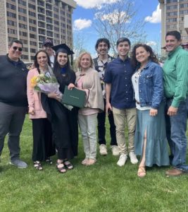 Rebeca Naredo, in cap and gown, surrounded by loved ones