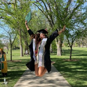 Kamryn Montera celebrating on The Oval with her bachelor's degree