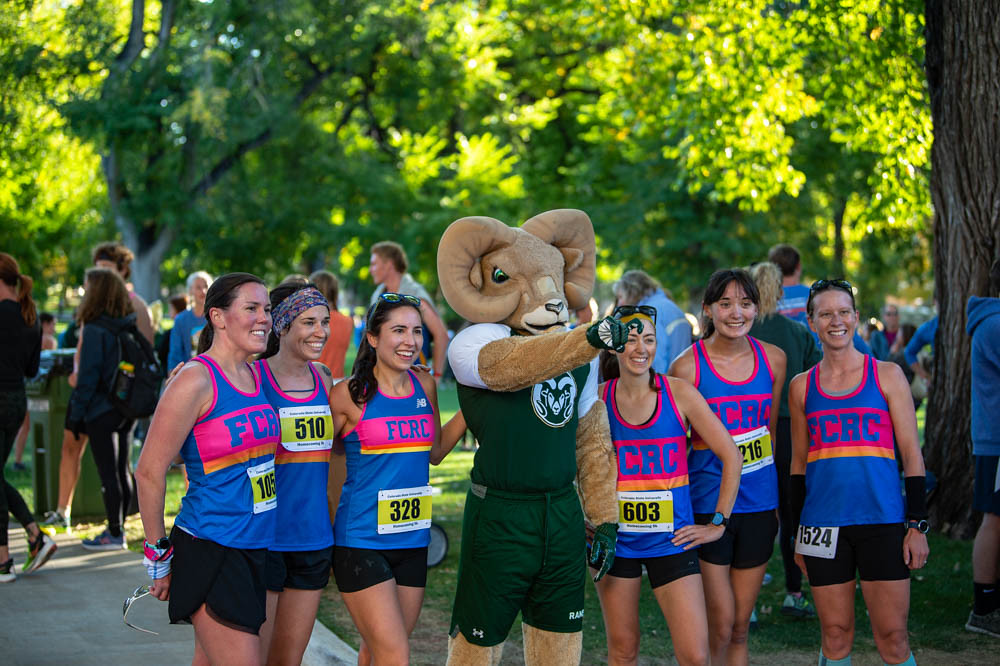 Cam the Ram with a group of 6 runners in matching shirts