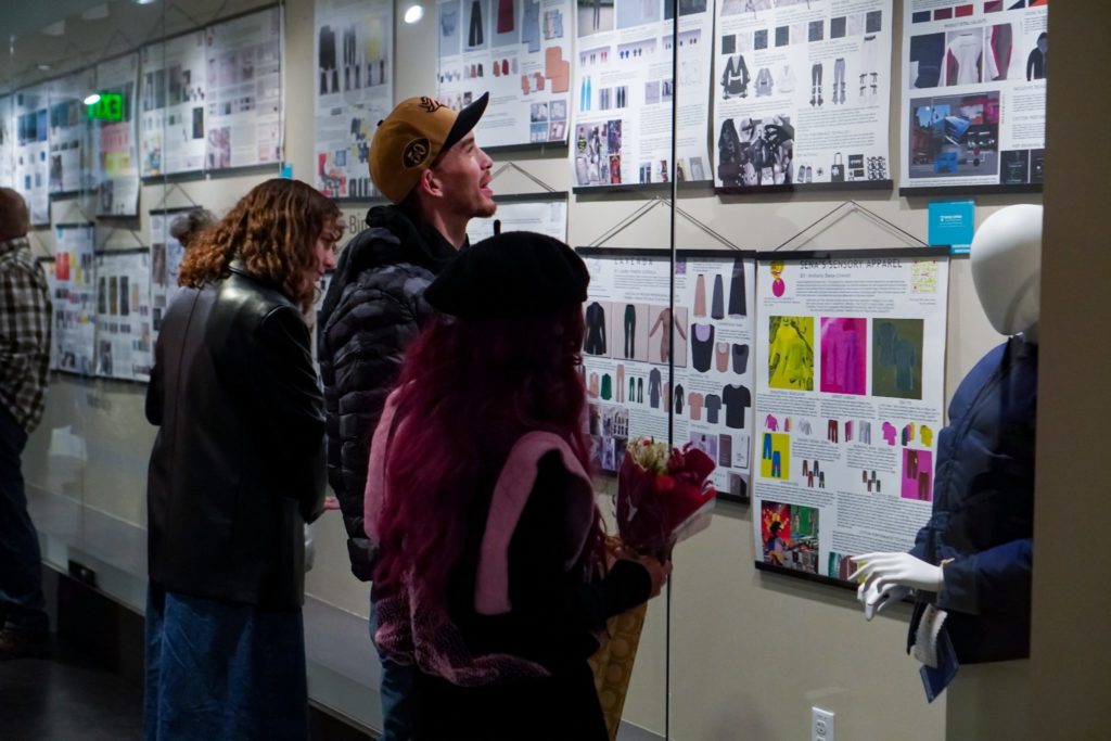 Students and program attendees admire the student poster exhibition