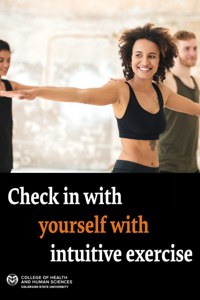 Check in with yourself with intuitive exercise | Photo - a woman with a small natural afro spreads her arms out in a stretch and smiles, with a man on the right behind her also stretching, and a woman off on the left barely in frame 