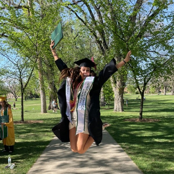 Kamryn Montera posing on the oval with her diploma