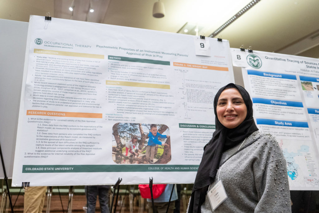 Rana Alarawi standing in front of her research board