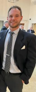 Thomas Rausch in a suit at a conference.