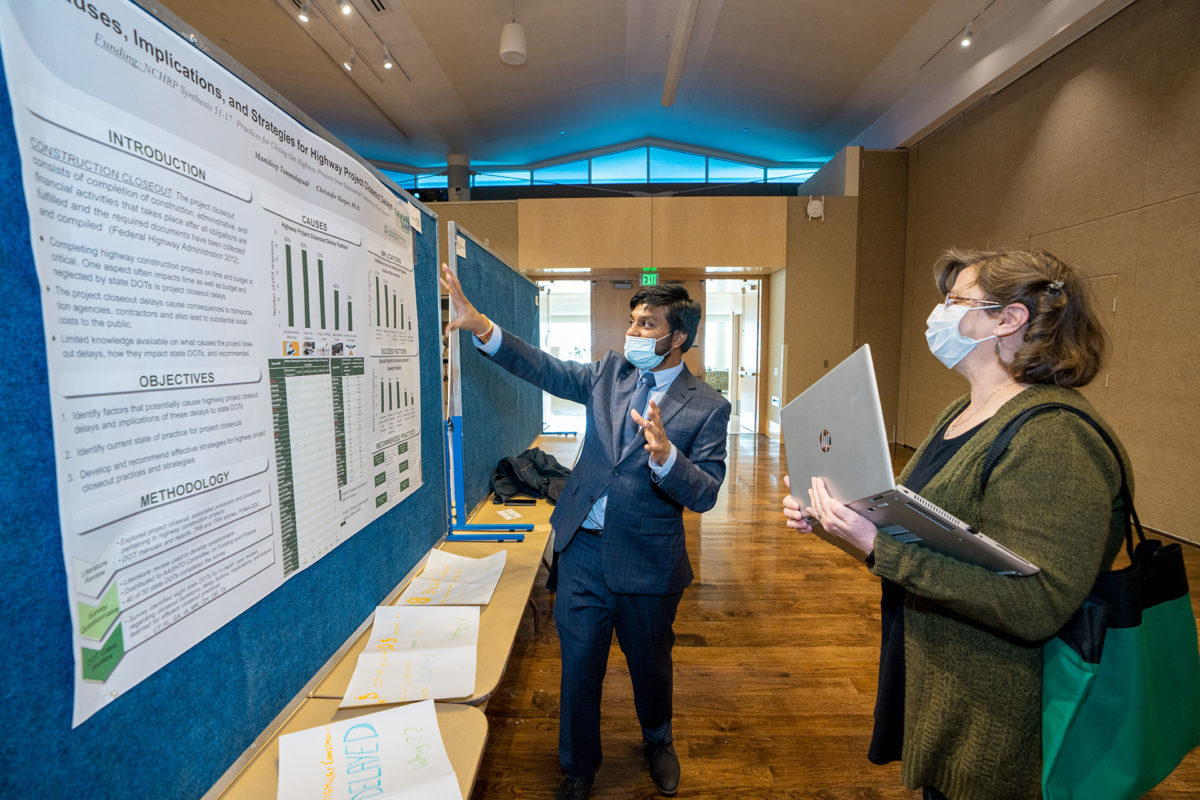 Student displays their poster during College of Health and Human Sciences Research Day