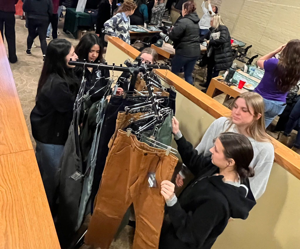 Students perusing the workwear on racks