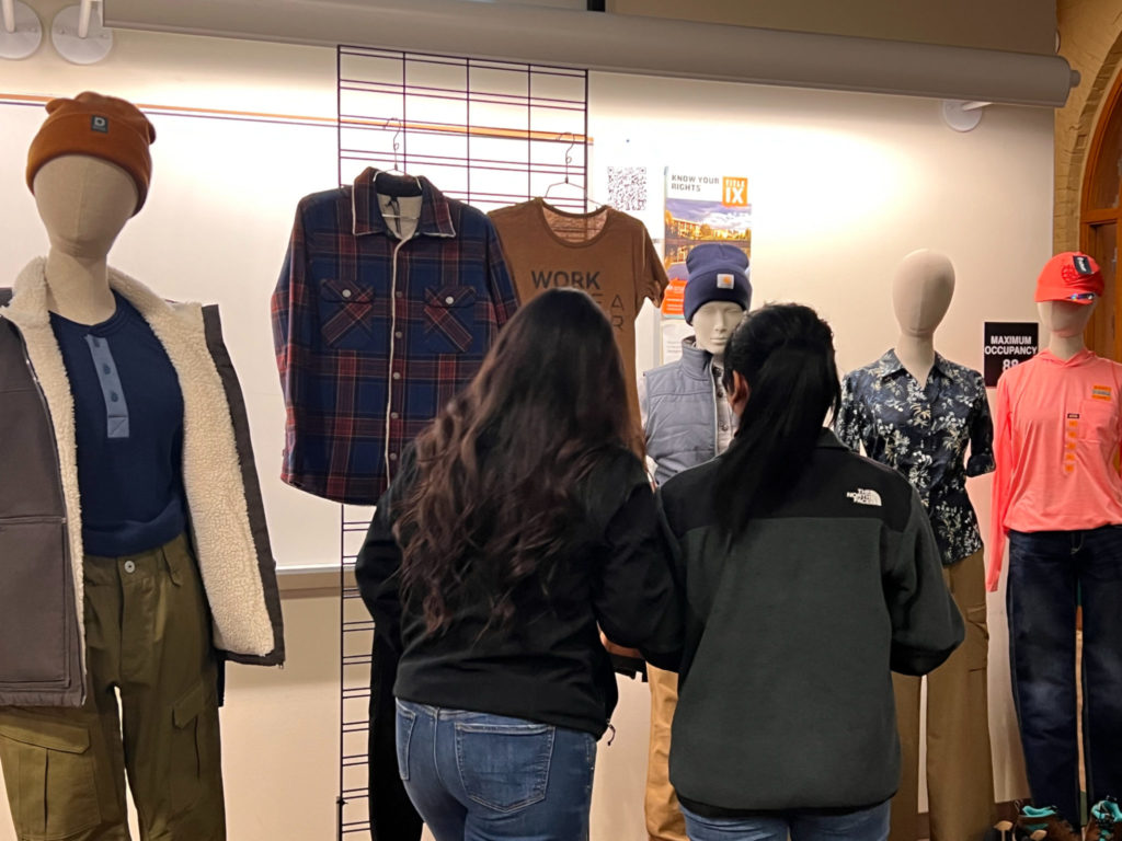 Students looking at the clothing on mannequins