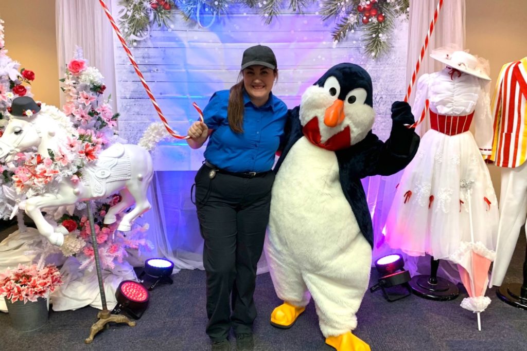 Audrey in uniform with a penguin in cosume from the Marry Poppins show.