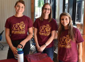 A professor and two students wearing matching University of Minnesota t-shirts