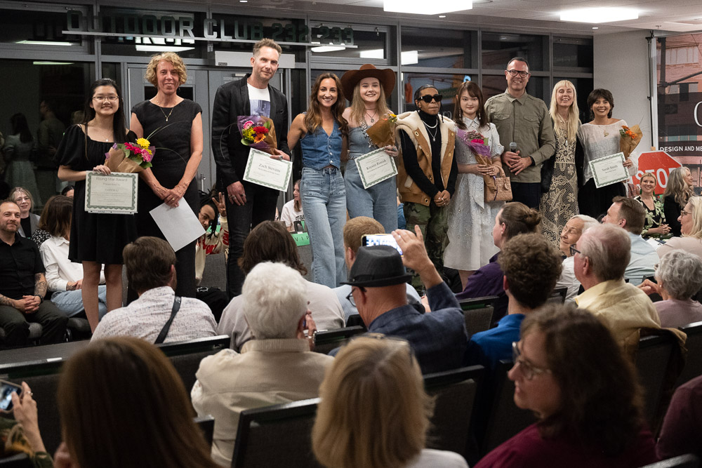 This is a group photo of award winners at the 2023 CSU fashion show next to their peers, professors, and judges.