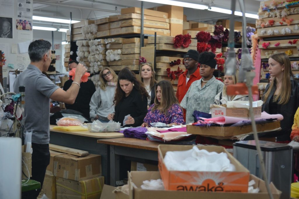 AM students observe a demonstration on fabric flowers
