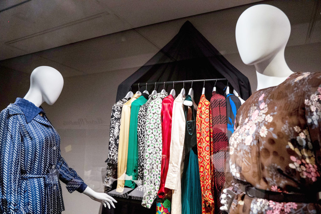 The Avenir Museum features a collection of items honoring the heirlooms and heritage of James Galanos. This photo shows two outfits and several more hung up as if in a closet.