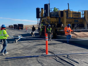 I-25 North expansion paving project with workers and heavy equipment