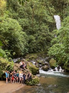 Martinez and other students pose next to a waterfall in Costa Rica.