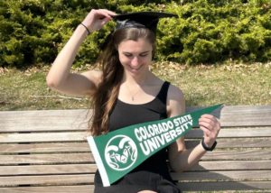 Megan Battleson with her graduation cap and a CSU flag