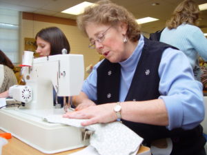 Karen Atler using a sewing machine