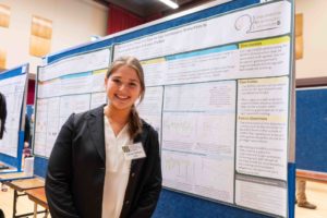 Female student with her research poster