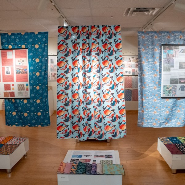 Textile examples hanging in an exhibit