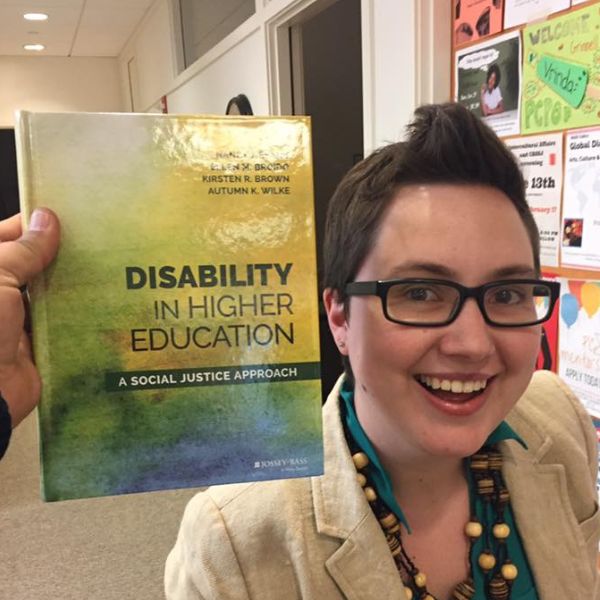 Autumn Wilke next to a book titled 'Disability in Higher Education'