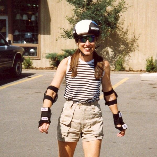 Kathryn Bohannon roller-skating in helmet and elbow pads