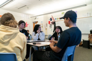 A Caminos Femtor working with students in a Fort Collins High School classroom.