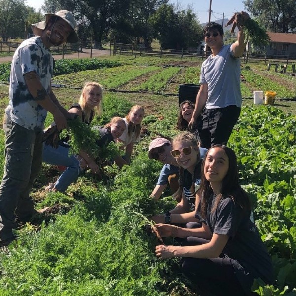 Sydney Coons and other students working in a garden