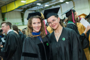 A faculty member and student in commencement regalia