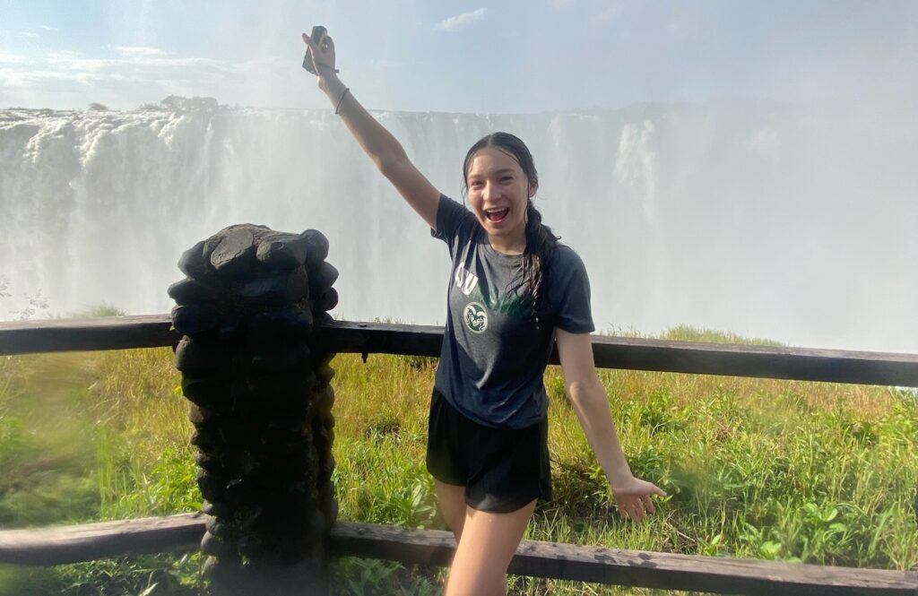 Kiara poses in front of a waterfall