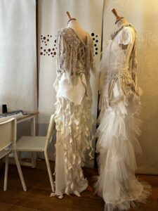 Two mannequins displaying long dress garments
