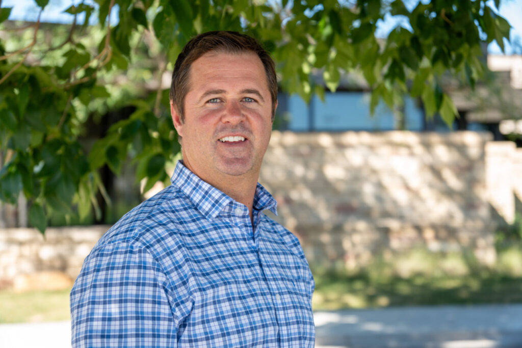 Scott Burley smiles under a tree outside CSU's Human Performance Clinical Research Laboratory