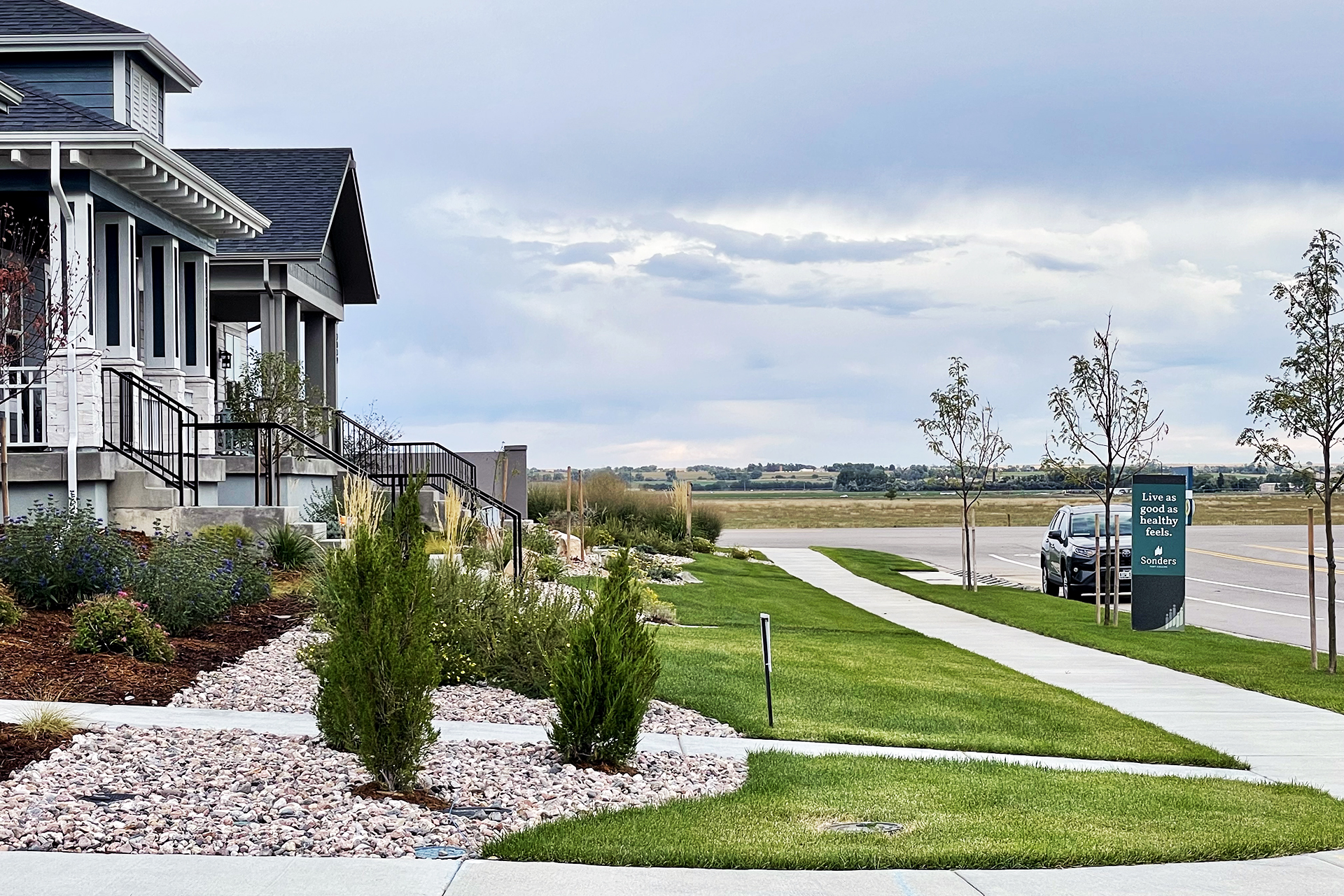 Looking down a street of new homes at Sonders Fort Collins, a housing development featuring some homes with a Lifelong Homes precertification.