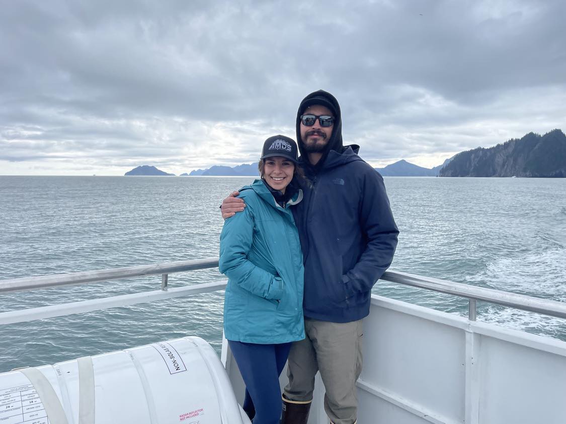 Guy and her husband pose for a photo in Alaska on a boat