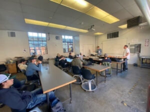 Lab classroom with students and 2 instructors in front of class