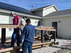 CM Cares students working on the deck and ramp in front of Iker's home
