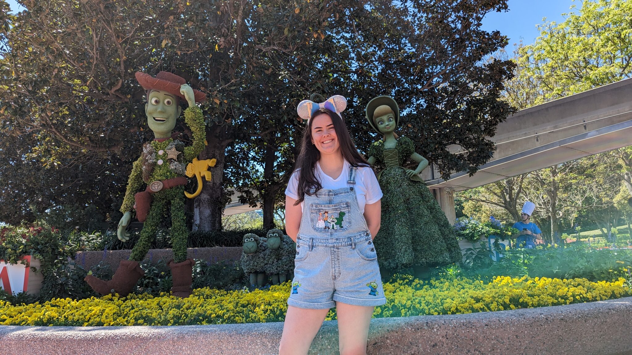 Ashley poses with Mickey Mouse ears at a Disney theme park.