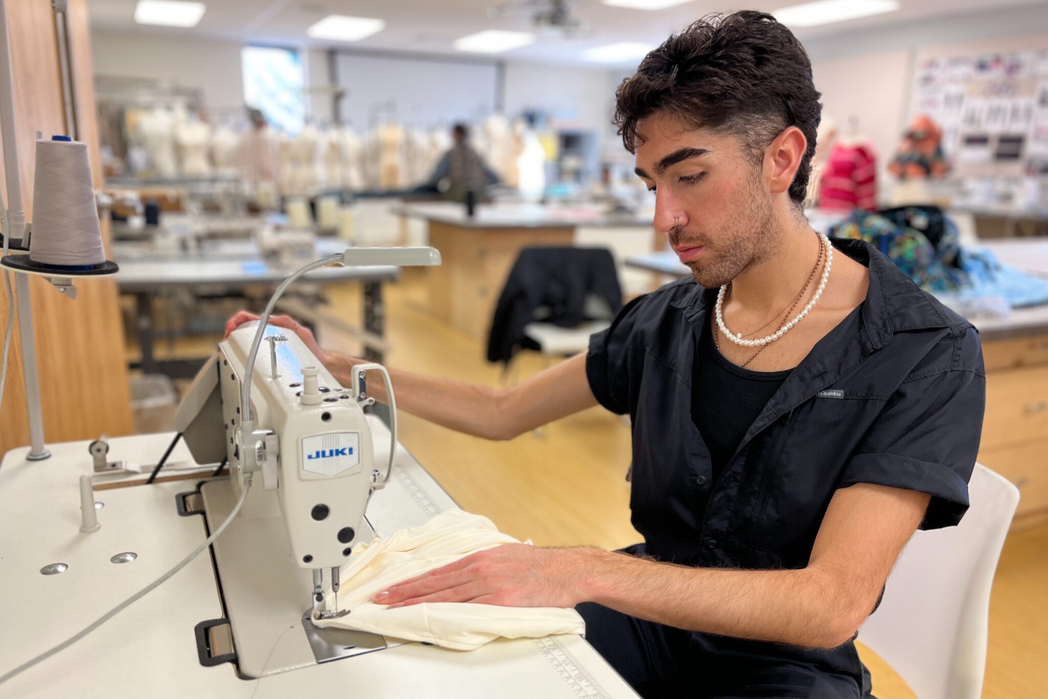 Shaheen working at the serger