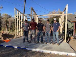 The CM Cares 5 member male team for Wiley Acres standing in front of the framing for the restroom