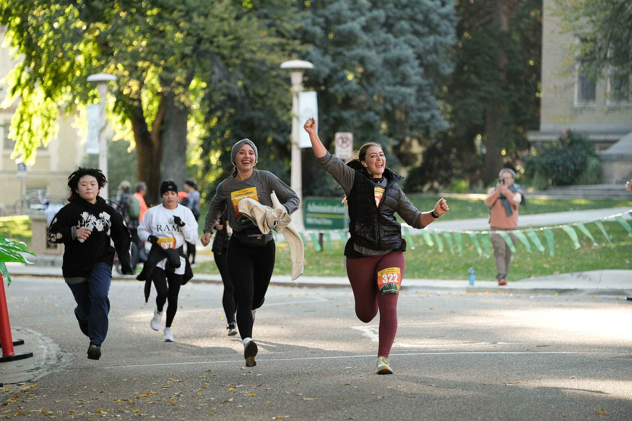 Two runners cheer as they near the finish line