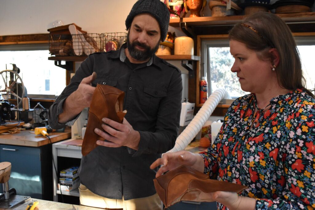 Dan and Kristen Morris examine the initial construction of a leather shoe.