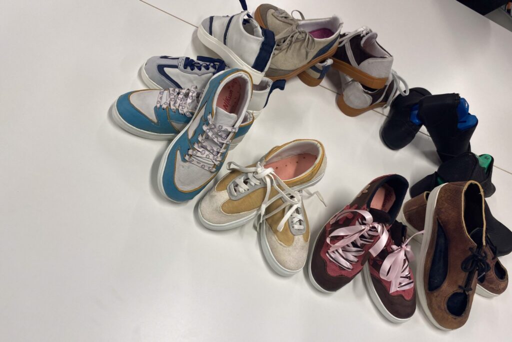 an image that shows 5 pairs of shoes laid out in a circle all created by the students in the class.