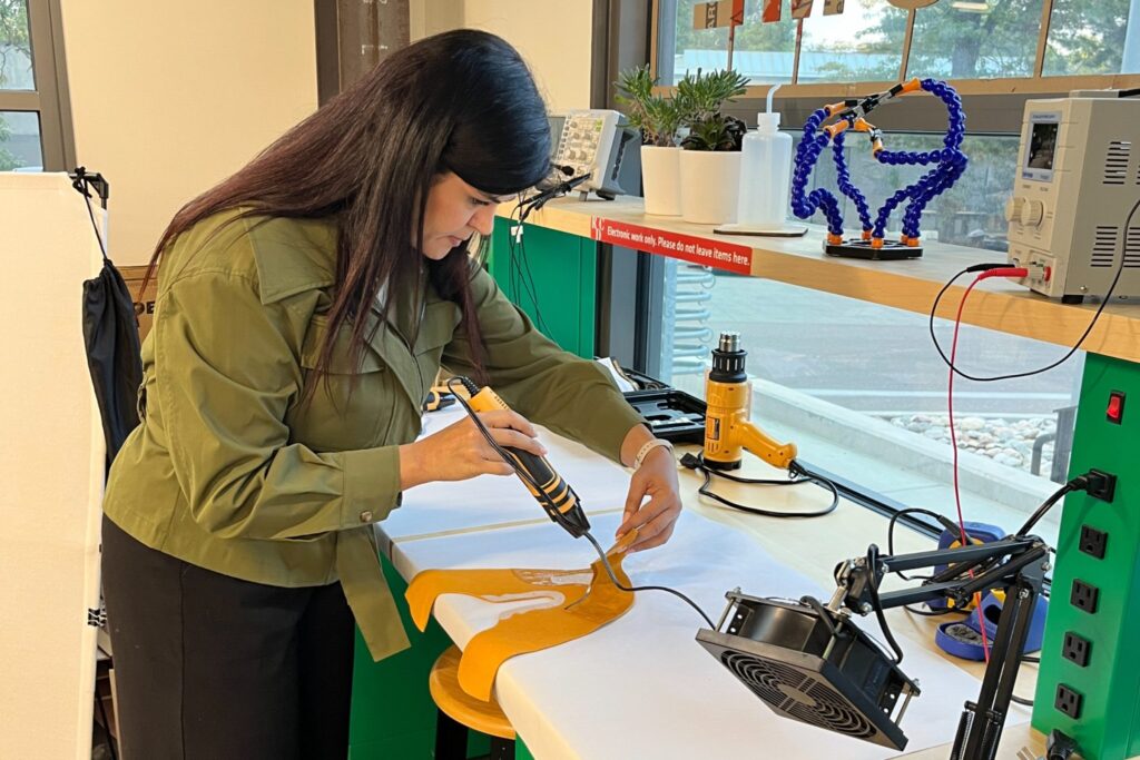Assistant Professor Lida Aflatoony uses the technology at the Richardson Design Center to demonstrate shoe construction
