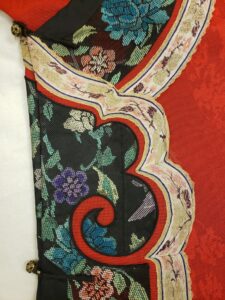Floral details on a red silk robe