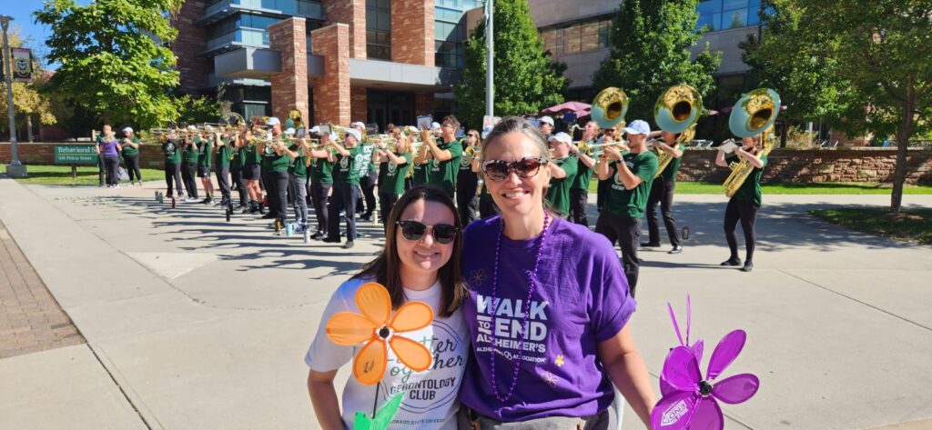 Dr. Fruhauf and Rachel at the 2023 End to Walk Alzheimer's with CSU Marching band in the background
