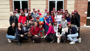 Group of students with red hats posing in a large group